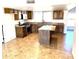 Large kitchen with an island, granite countertops, tile floors, and cabinets at 1440 E Grove Ave, Mesa, AZ 85204