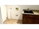 Well-lit laundry room featuring a granite countertop sink and modern fixtures at 1440 E Grove Ave, Mesa, AZ 85204