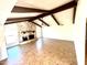 Spacious living room with a stone fireplace and beautiful ceiling beams at 1440 E Grove Ave, Mesa, AZ 85204