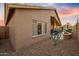 Inviting covered back patio with comfortable seating, decorative plants and a clear view of the fenced yard at 14728 W Cheery Lynn Dr, Goodyear, AZ 85395