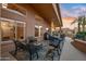 Inviting covered back patio with comfortable seating, decorative plants and a clear view of the fenced yard at 14728 W Cheery Lynn Dr, Goodyear, AZ 85395