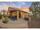 Inviting covered back patio with comfortable seating, decorative plants and a clear view of the fenced yard at 14728 W Cheery Lynn Dr, Goodyear, AZ 85395