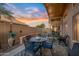 Inviting covered back patio with comfortable seating, decorative plants and a clear view of the fenced yard at 14728 W Cheery Lynn Dr, Goodyear, AZ 85395