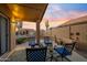 Inviting covered back patio with comfortable seating, decorative plants and a clear view of the fenced yard at 14728 W Cheery Lynn Dr, Goodyear, AZ 85395