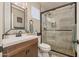 Modern bathroom with a glass-enclosed shower, updated vanity, and contemporary fixtures at 14728 W Cheery Lynn Dr, Goodyear, AZ 85395