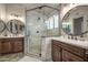 Elegant bathroom showcasing dual vanities and a frameless glass shower with modern fixtures at 14728 W Cheery Lynn Dr, Goodyear, AZ 85395