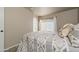 Bright bedroom featuring a large window, neutral-colored walls and patterned quilt at 14728 W Cheery Lynn Dr, Goodyear, AZ 85395