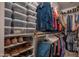 Organized walk-in closet featuring shoe racks, shelves, and hanging storage for clothes and accessories at 14728 W Cheery Lynn Dr, Goodyear, AZ 85395