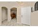 Inviting entryway featuring an arched doorway, tile flooring, and a warm, neutral color palette at 14728 W Cheery Lynn Dr, Goodyear, AZ 85395