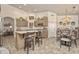 Bright kitchen featuring an island with seating, stainless steel appliances, and an adjacent dining area at 14728 W Cheery Lynn Dr, Goodyear, AZ 85395