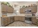 Modern kitchen with stainless steel appliances, decorative tile backsplash, and ample counter space at 14728 W Cheery Lynn Dr, Goodyear, AZ 85395