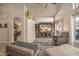 Well-lit living room with stylish furniture, a large TV, and an open doorway to the kitchen at 14728 W Cheery Lynn Dr, Goodyear, AZ 85395