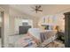 Comfortable main bedroom features neutral tones, tile floor and a ceiling fan at 14728 W Cheery Lynn Dr, Goodyear, AZ 85395