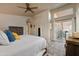 Bright primary bedroom features neutral tones, tile floor and sliding doors to the patio at 14728 W Cheery Lynn Dr, Goodyear, AZ 85395