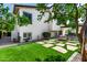 Expansive backyard with lush green grass, a modern fire pit, and ample space for outdoor entertaining at 14820 N 44Th Pl, Phoenix, AZ 85032