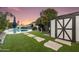 Lush backyard featuring a pool, a manicured lawn and a charming garden shed, perfect for outdoor living at 14820 N 44Th Pl, Phoenix, AZ 85032