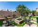 Beautiful backyard features a fire pit with chairs, lush landscaping, and a well-maintained lawn at 14820 N 44Th Pl, Phoenix, AZ 85032