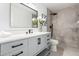 Modern bathroom with a sleek vanity, large mirror, and walk-in shower with neutral tile at 14820 N 44Th Pl, Phoenix, AZ 85032