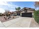 Charming single-story home featuring a desert landscape, a two-car garage, and black trim accents at 14820 N 44Th Pl, Phoenix, AZ 85032