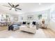 Open-concept living room with a large sofa, a ceiling fan, and lots of natural light at 14820 N 44Th Pl, Phoenix, AZ 85032