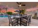 Outdoor patio featuring a pool, dining area, and lush landscaping at sunset at 14820 N 44Th Pl, Phoenix, AZ 85032