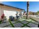 Cozy outdoor patio area with modern seating, pavers, and a lush green landscape at 14820 N 44Th Pl, Phoenix, AZ 85032