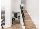 Staircase leading to the open-concept living room, with a view of the fireplace at 14820 N 44Th Pl, Phoenix, AZ 85032