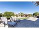 Relaxing backyard featuring lounge chairs, patio area, and meticulously maintained landscaping, ideal for outdoor living at 16416 W Rock Springs Ln, Surprise, AZ 85374