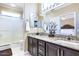 This bathroom boasts granite countertops, dark wood cabinets, and a shower, creating an elegant and functional space at 16416 W Rock Springs Ln, Surprise, AZ 85374