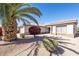 Charming single story home with stucco facade and well-manicured desert landscaping featuring beautiful bougainvillea at 16416 W Rock Springs Ln, Surprise, AZ 85374