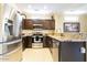 Well-equipped kitchen featuring stainless steel appliances, granite countertops, and dark wood cabinetry at 16416 W Rock Springs Ln, Surprise, AZ 85374