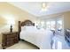 Bright main bedroom features tiled floors, a ceiling fan, and a large window with a view of the backyard at 16416 W Rock Springs Ln, Surprise, AZ 85374