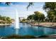 Picturesque pond with a towering fountain surrounded by lush greenery and trees, creating a serene atmosphere at 16416 W Rock Springs Ln, Surprise, AZ 85374