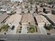 Aerial view of a neighborhood home with a well-maintained lawn, landscaping, and proximity to other homes at 1658 W Paisley Dr, San Tan Valley, AZ 85144