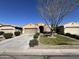 Charming home with a well-manicured lawn and garden, driveway, and a two-car garage at 1658 W Paisley Dr, San Tan Valley, AZ 85144