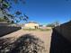 View of the backyard with a gravel ground cover and block fencing providing privacy at 17345 N Costa Brava Ave, Maricopa, AZ 85139