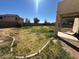 Backyard showcasing desert landscaping with a covered patio and block wall for added seclusion at 17345 N Costa Brava Ave, Maricopa, AZ 85139