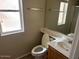 Functional bathroom featuring a single sink vanity and a window for natural light at 17345 N Costa Brava Ave, Maricopa, AZ 85139