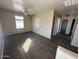 Spacious carpeted bedroom featuring a ceiling fan and natural light from the window at 17345 N Costa Brava Ave, Maricopa, AZ 85139