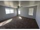 Spacious carpeted bedroom featuring large windows at 17345 N Costa Brava Ave, Maricopa, AZ 85139