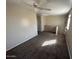 Upstairs hallway features carpeted floors and natural light at 17345 N Costa Brava Ave, Maricopa, AZ 85139