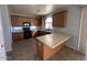 Well-equipped kitchen with wood cabinetry, black appliances, and a functional layout at 17345 N Costa Brava Ave, Maricopa, AZ 85139