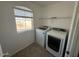 Bright laundry room with washer and dryer at 17345 N Costa Brava Ave, Maricopa, AZ 85139