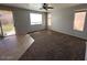 Spacious living room featuring natural light, tile accents, and neutral wall colors at 17345 N Costa Brava Ave, Maricopa, AZ 85139