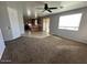 Open living space seamlessly connected to the kitchen, with natural light and neutral finishes at 17345 N Costa Brava Ave, Maricopa, AZ 85139