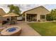 Back patio with comfortable outdoor furniture, BBQ grill, and desert landscaping at 17507 W Fetlock Trl, Surprise, AZ 85387