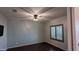 Well-lit bedroom with a ceiling fan, wood-look floors and window with wood shutter blinds at 17507 W Fetlock Trl, Surprise, AZ 85387