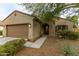 Charming single-story home featuring a well-kept front yard with mature landscaping and a two-car garage at 17507 W Fetlock Trl, Surprise, AZ 85387