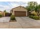 Two car garage with a well maintained front yard and desert landscaping at 17507 W Fetlock Trl, Surprise, AZ 85387