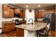 Kitchen featuring an island with granite countertop, stainless steel appliances and wood cabinets at 17507 W Fetlock Trl, Surprise, AZ 85387